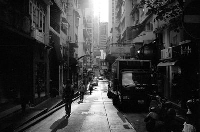 Street amidst buildings in city at night