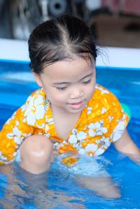 Portrait of cute girl swimming in pool