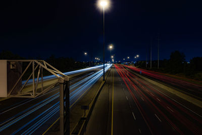 High angle view of light trails on road against sky at night