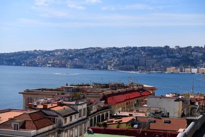 High angle view of townscape by sea