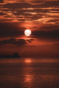 Scenic view of sea against orange sky during sunset