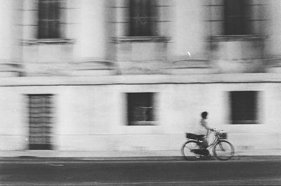 Blurred motion of people walking on road