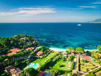 High angle view of sea and buildings against sky