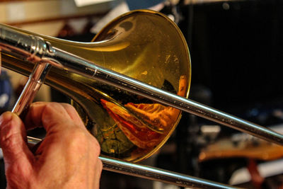 Cropped hand of man playing trumpet