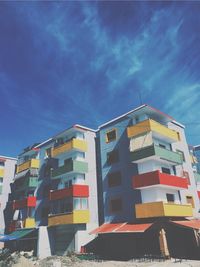 Low angle view of houses against blue sky