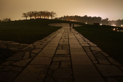 View of footpath at night