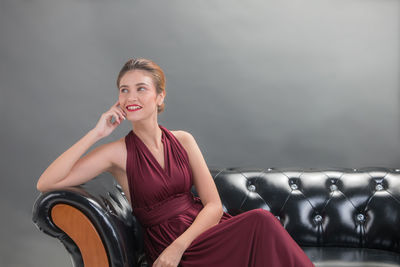 Portrait of smiling young woman sitting on seat