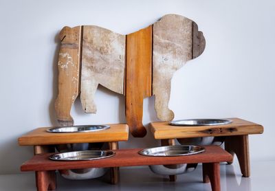 Close-up of chair on table against wall