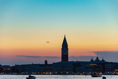 Plane flying close to the campanile of venice 