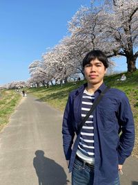 Portrait of young man standing on land