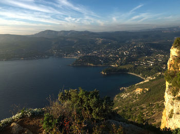 High angle view of city by sea against sky