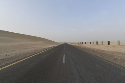 Empty road against clear sky