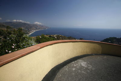 Building terrace by sea against sky