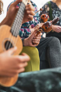 Midsection of woman playing guitar