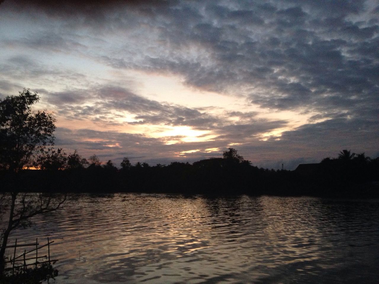 sunset, water, sky, silhouette, tranquil scene, tranquility, scenics, beauty in nature, tree, lake, cloud - sky, nature, waterfront, reflection, idyllic, cloud, orange color, cloudy, river, dramatic sky