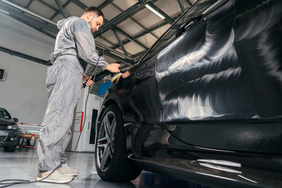 Side view of young man cycling