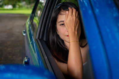 Portrait of a beautiful young woman in car