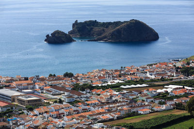 High angle view of townscape by sea