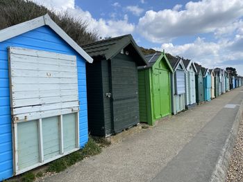 Built structure on beach by buildings against sky