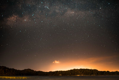 Scenic view of lake against star field at night