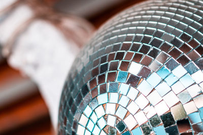 Partial view of a disco ball, with a blurred background