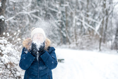 Woman playing with snow