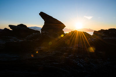 Rock formation at a fjord landscape in northern norway on a warm summer evening with midnight sun