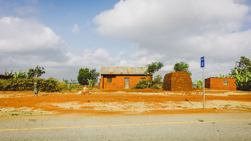 Abandoned building on field against sky