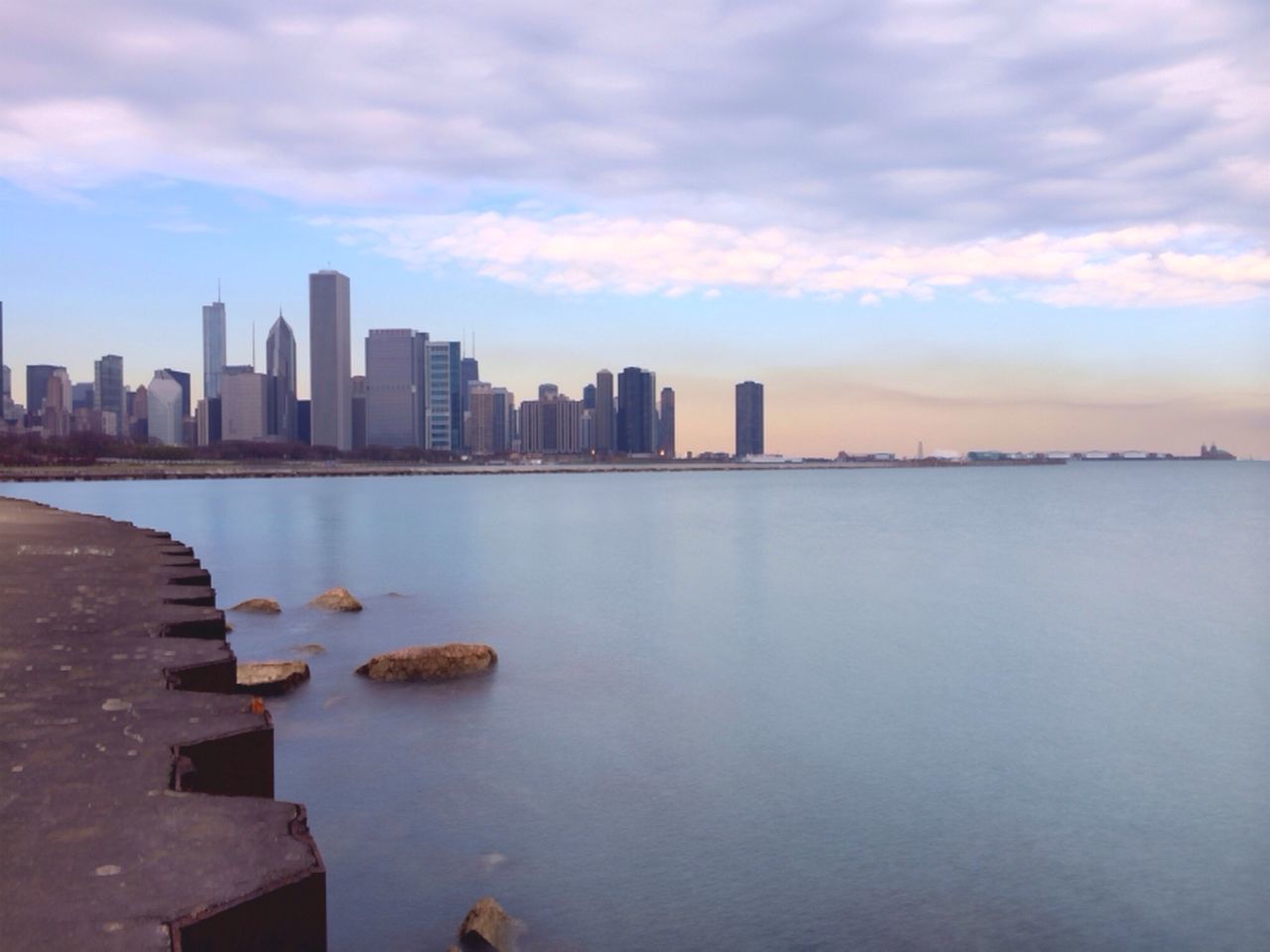 building exterior, architecture, water, city, built structure, sky, skyscraper, cityscape, urban skyline, cloud - sky, river, waterfront, sea, tower, cloud, tall - high, reflection, modern, skyline, office building