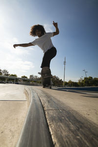 Young man practicing on skateboard at skateboard park