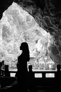 Side view of silhouette woman standing in temple