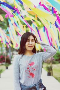 Portrait of happy woman standing against multi colored outdoors