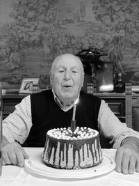 Portrait of smiling grandpa with birthday cake