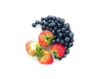 High angle view of berries against white background