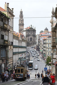 People on city street against buildings