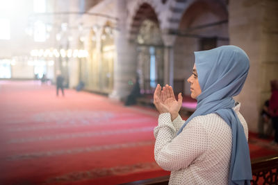 Side view of woman standing against text