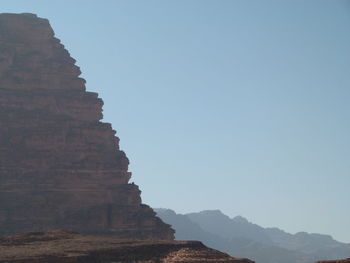 Low angle view of rock formation against clear sky in wadi rum