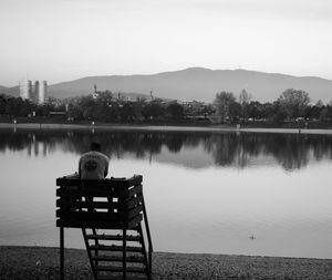 Scenic view of calm lake with mountains in background