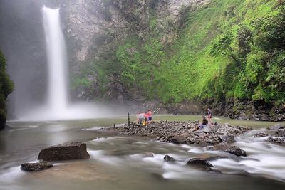 Scenic view of waterfall against sky