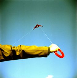 Low angle view of red balloons against blue sky