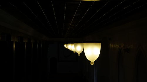 Low angle view of illuminated lamp at night