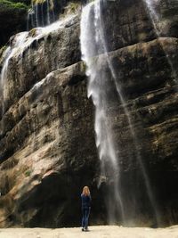 Full length of woman standing on rock formation