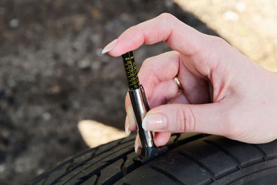 Cropped hand of woman repairing tire