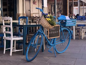 Bicycle on footpath against buildings in city