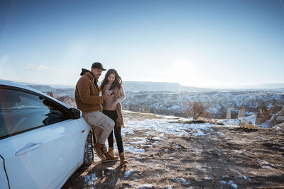 Rear view of couple walking on snow