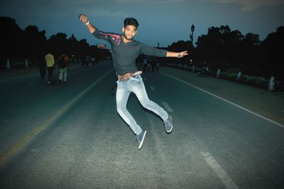 Full length of man skateboarding on road