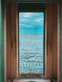 Scenic view of sea against sky seen through window