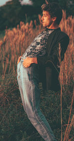 Side view of boy looking away on field
