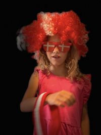 Portrait of woman with red hair against black background