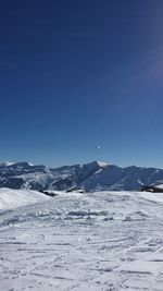 Scenic view of snowcapped mountains against clear blue sky